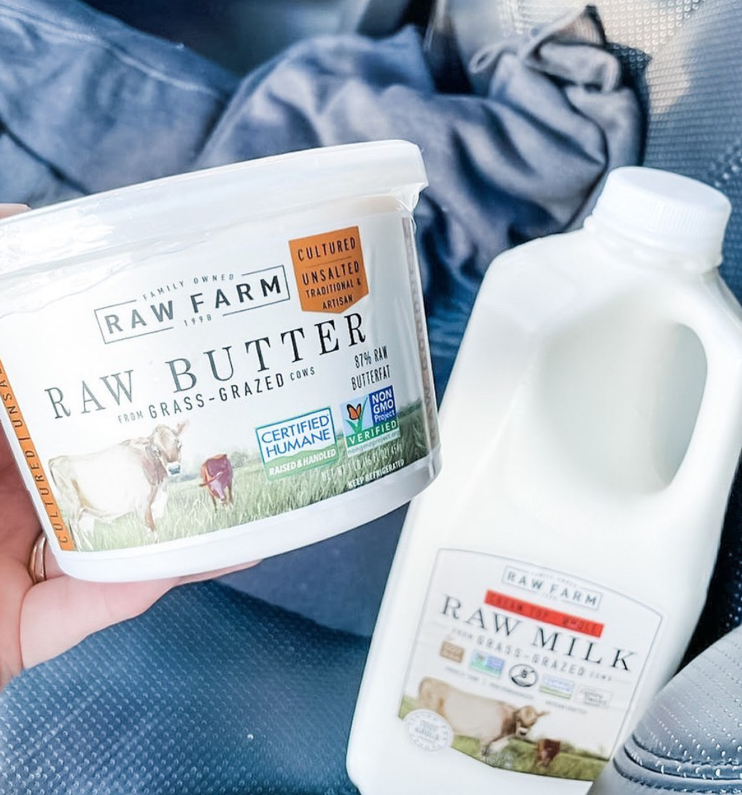 someone holding a tub of raw butter and raw milk