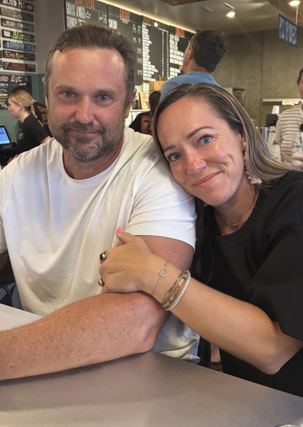 husband and wife arm in arm out at dinner