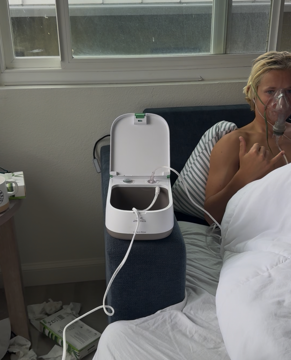 older child nebulzing in bed 